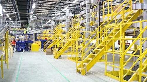 Yellow metal staircases and railings leading up to a mezzanine in a plant