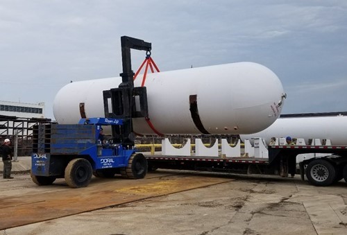 A Doral lift moving a large LP tank at a forge shop