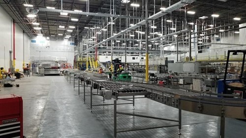 Floor level view of a conveyor system for a bottle line set up in a plant